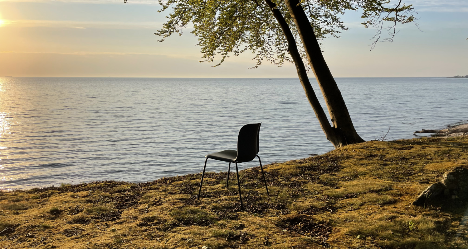 A grey SixE chair at the seaside 