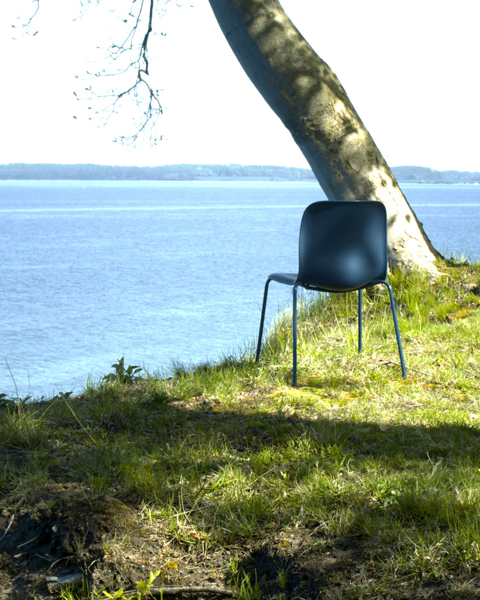 SixE chair captured on a hill by the sea