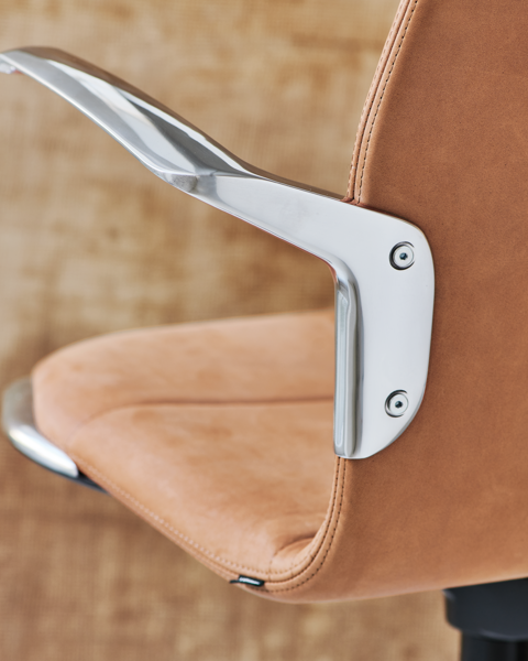 A detailed image of the armrest and seat of the AS100 chair