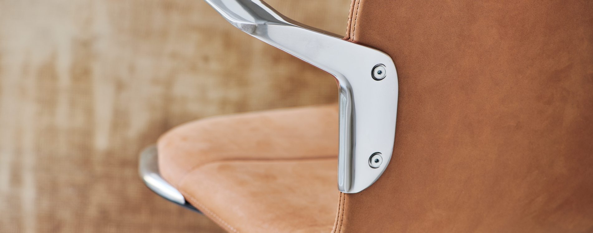 A detailed image of the armrest and seat of the AS100 chair