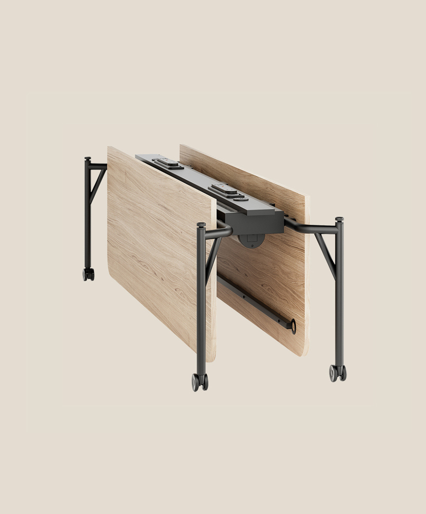 A Folding Surfaces bench desk with oak veneer top, folded, on a plain beige background