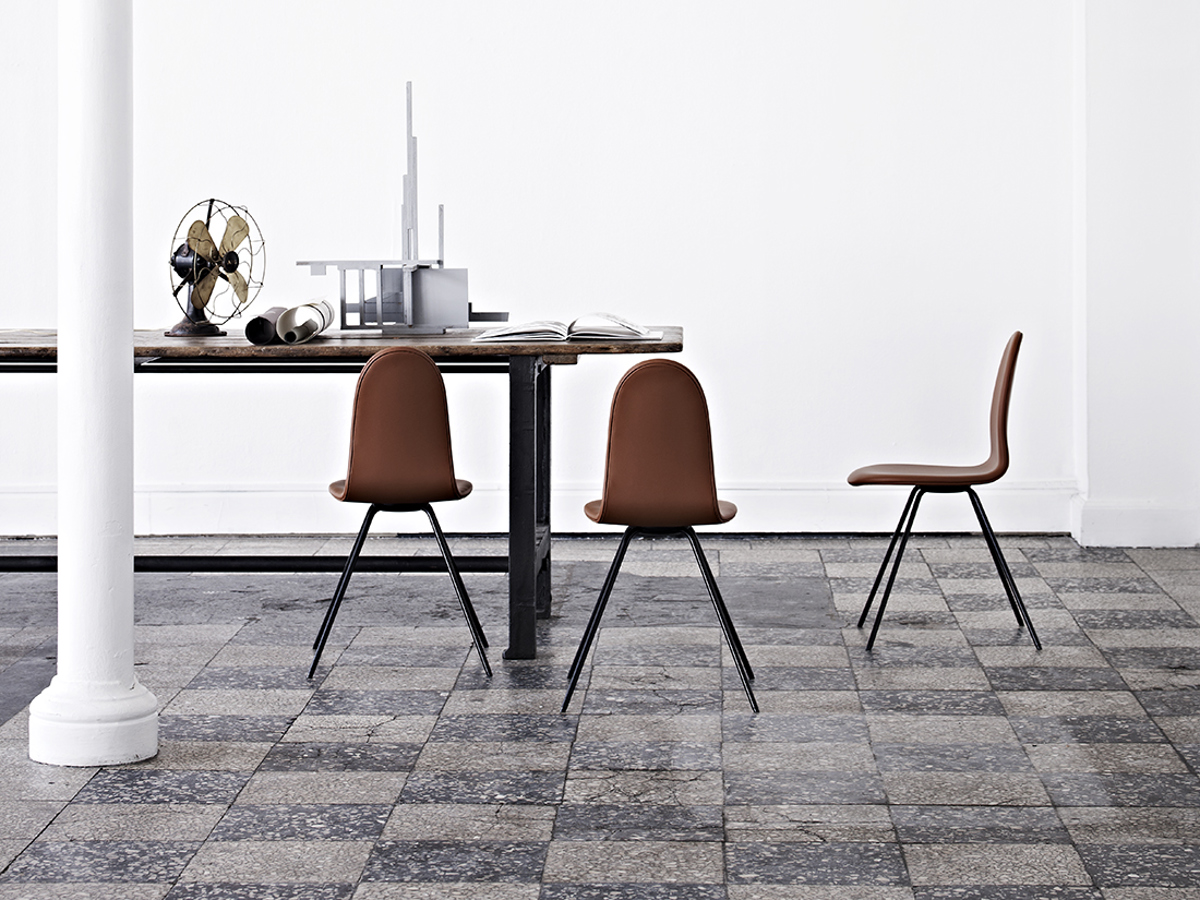 An installation image with three Tongue chairs upholstered in cognac leather