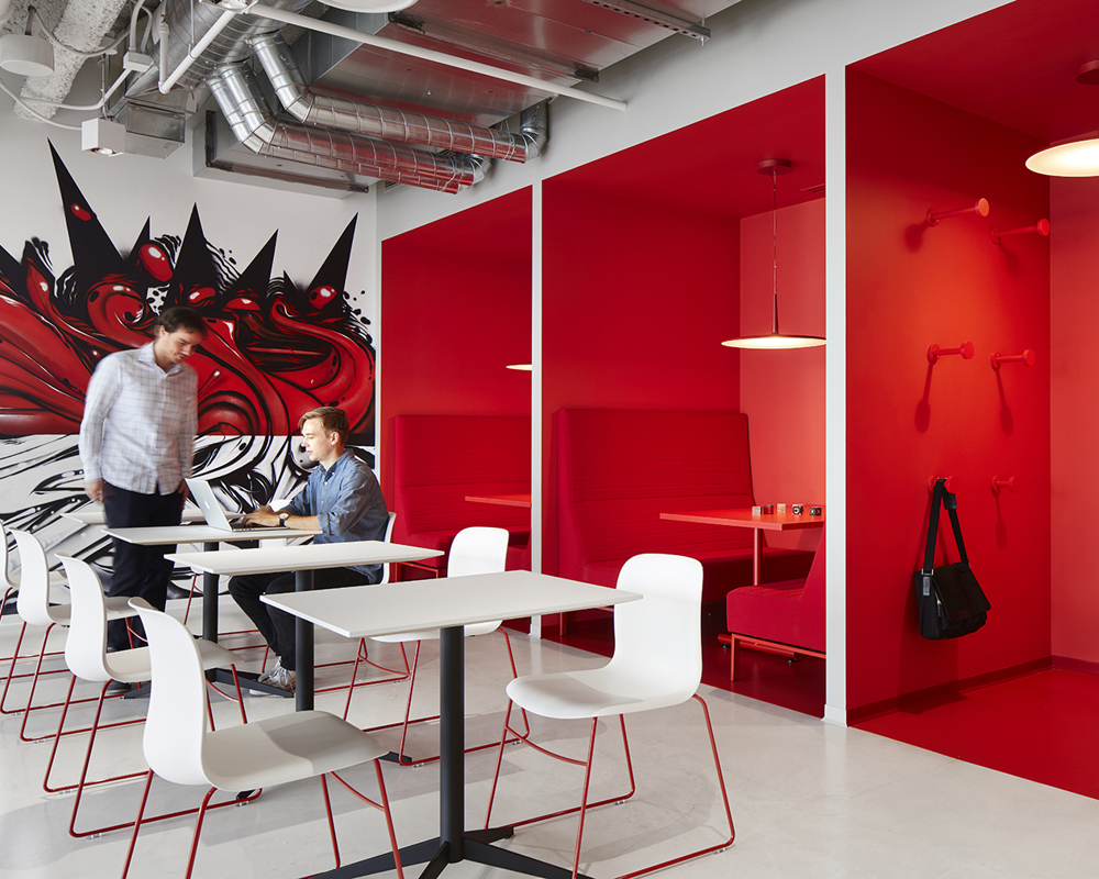 White SixE chairs with red sled frames around white tables in a red room