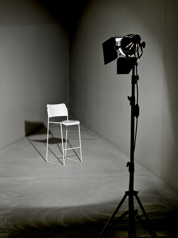 A black and white image of a 40/4 barstool in a spotlight