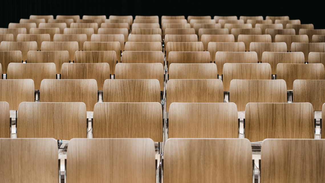 A picture of several rows of the veneer 40/4 side chairs with brace linking at Joensuu Conservatory