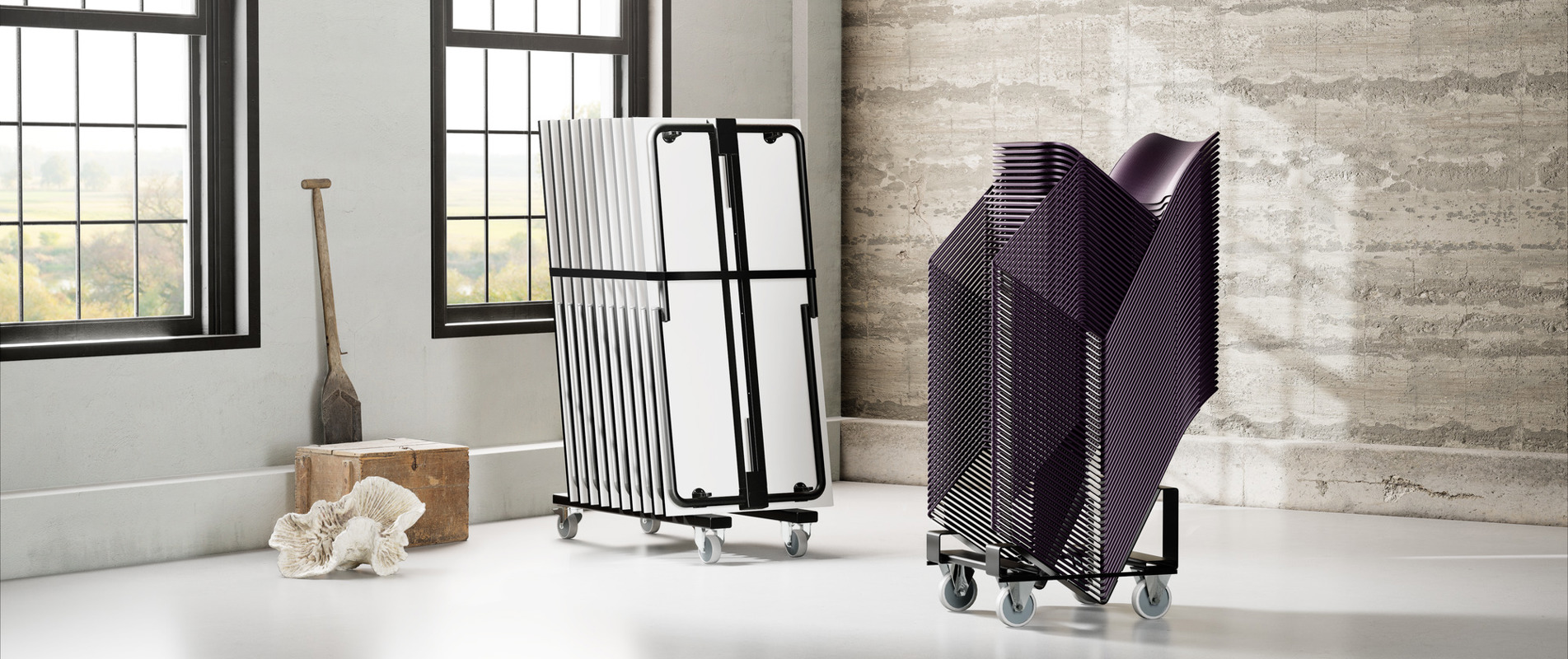 An installation image of a stack of Usu tableas and a stack of 40/4 chairs