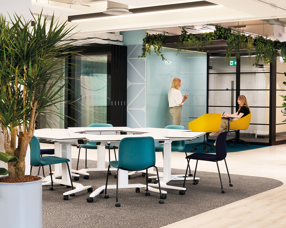 Colourful SixE castors chairs around white table at the Northeastern University