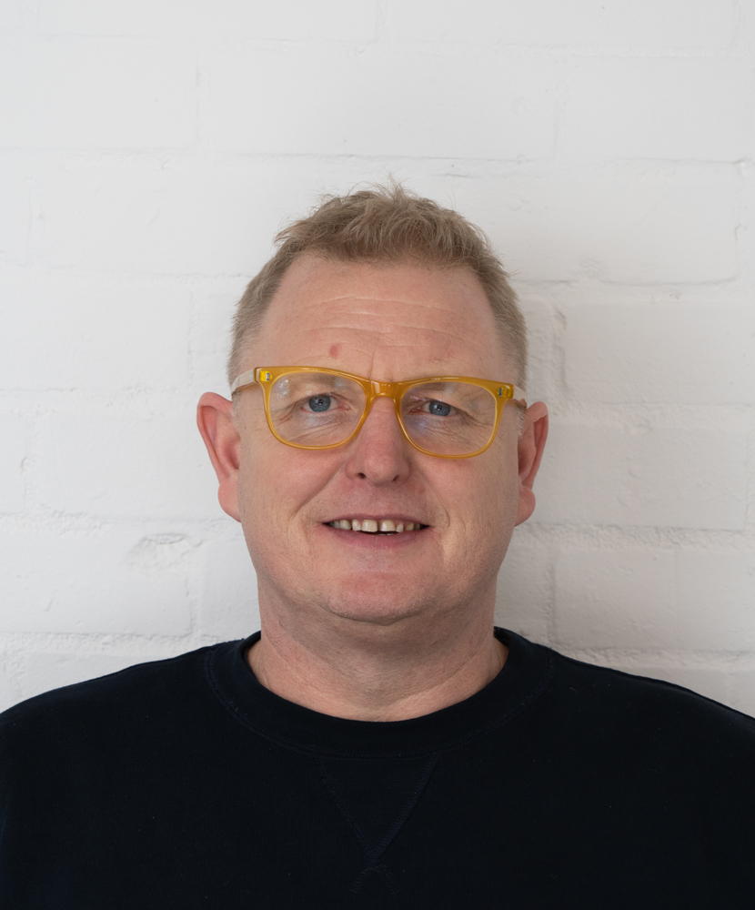 A portrait imange of Craig Jones in yellow glasses