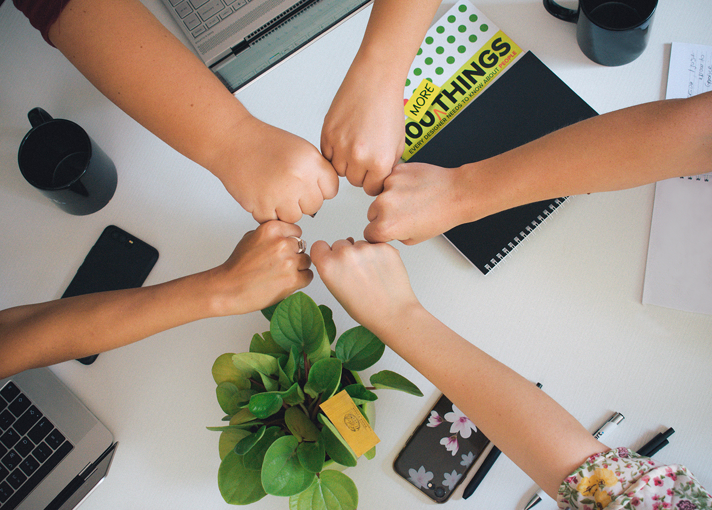 An image of five fists forming a powerful circle